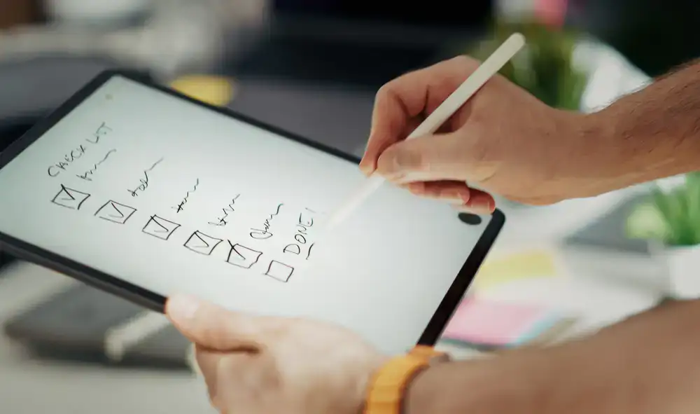 Virtual assistant reviewing task workflows on a digital tablet